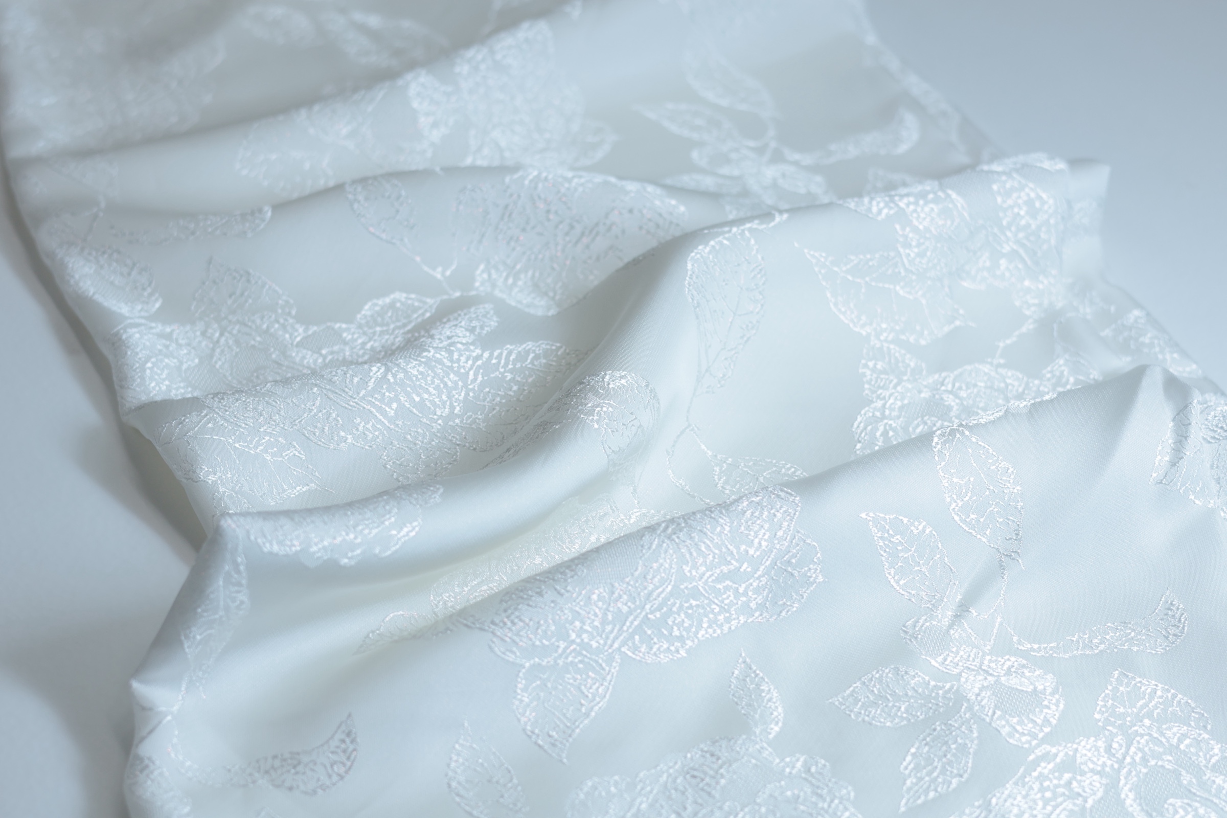 White oversized-rose jacquard photographed in natural folds