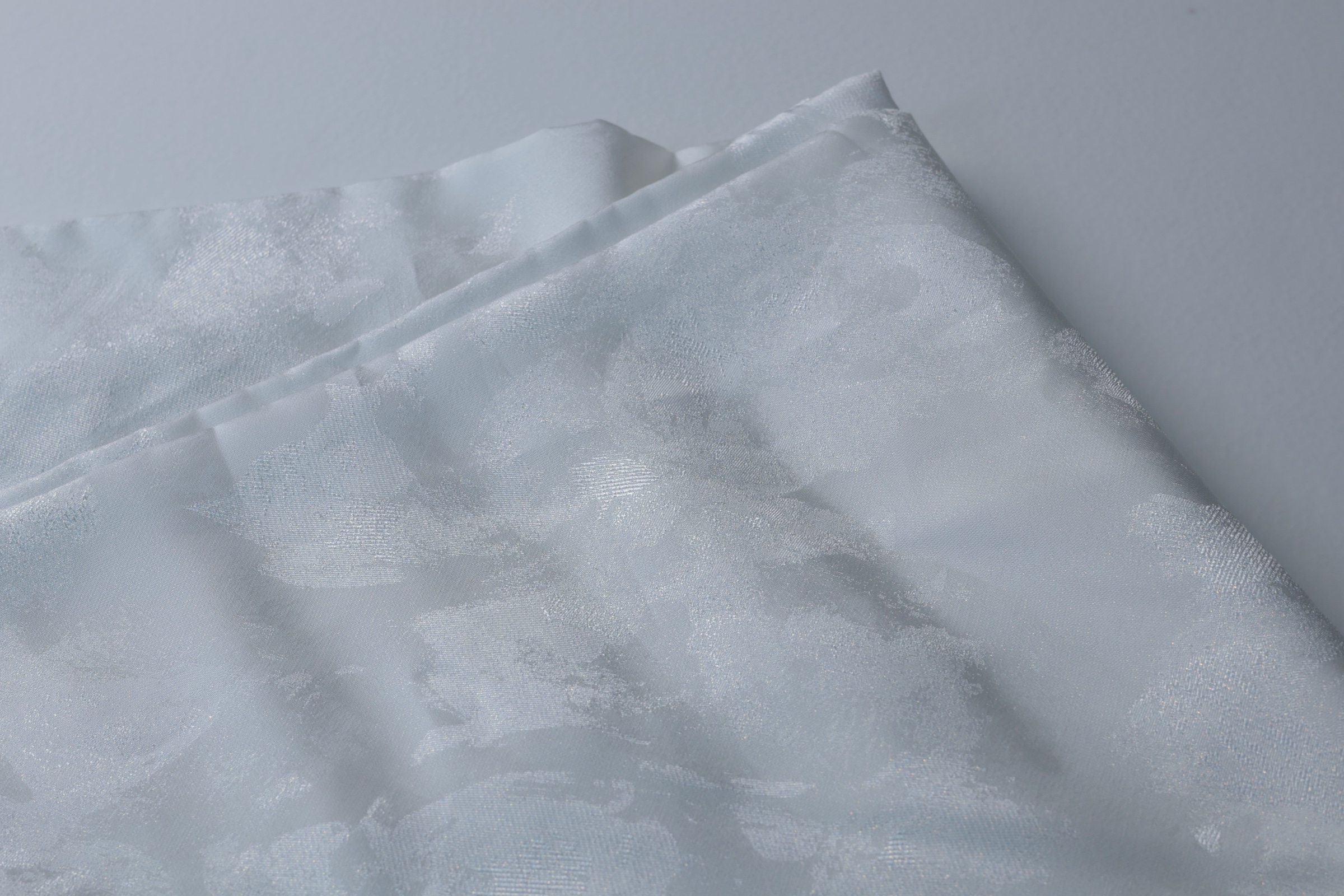 White hazy oversized-floral jacquard showing quiet tonal lustre